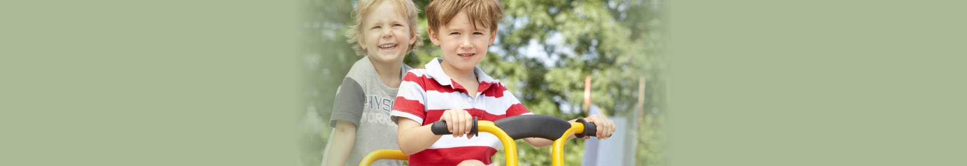two boys riding a tricycle